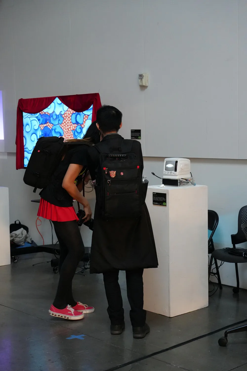 Two visitors trying Hey, Cili at the exhibition