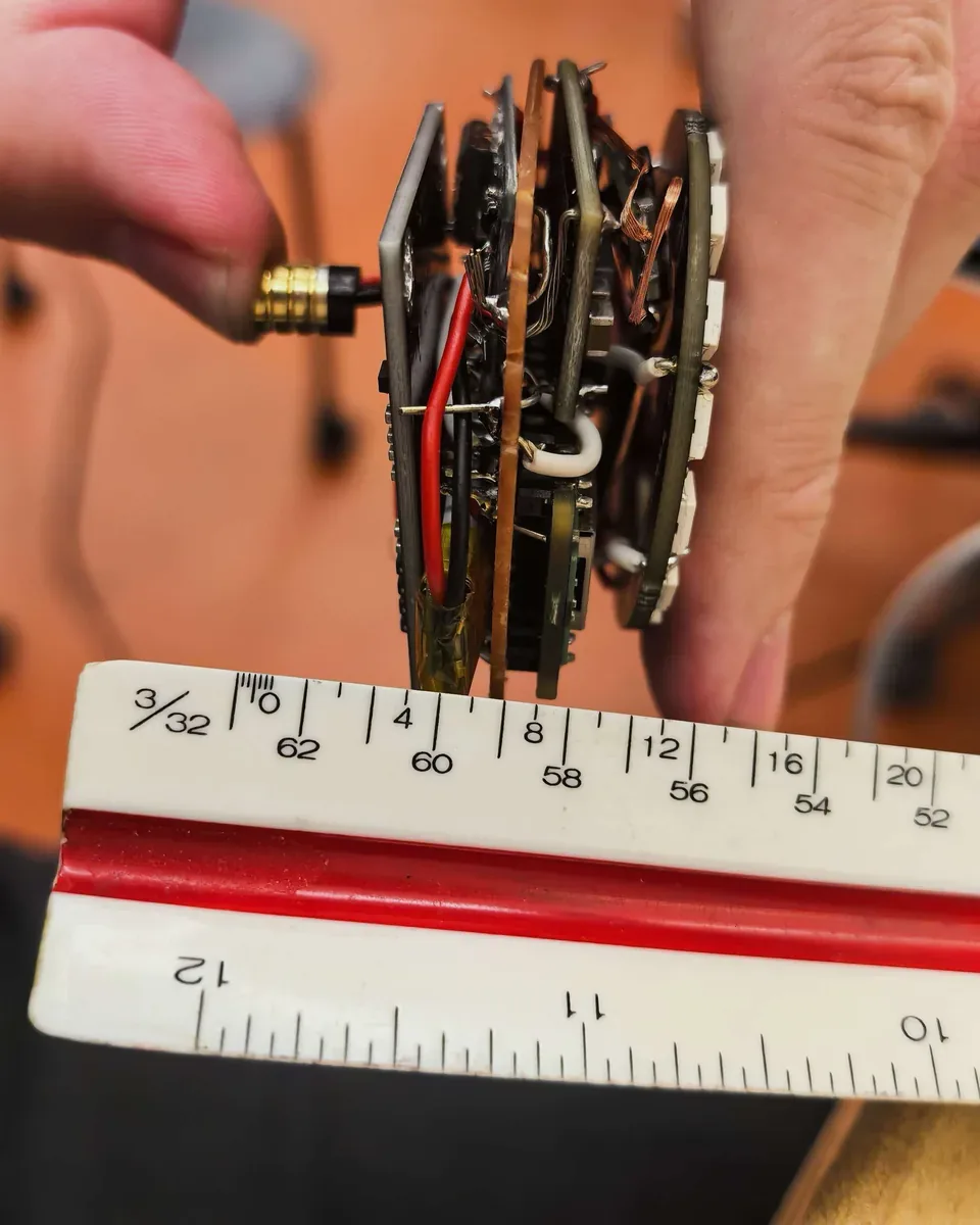 The stacked sensing boards of the Pebble prototype measured against a ruler