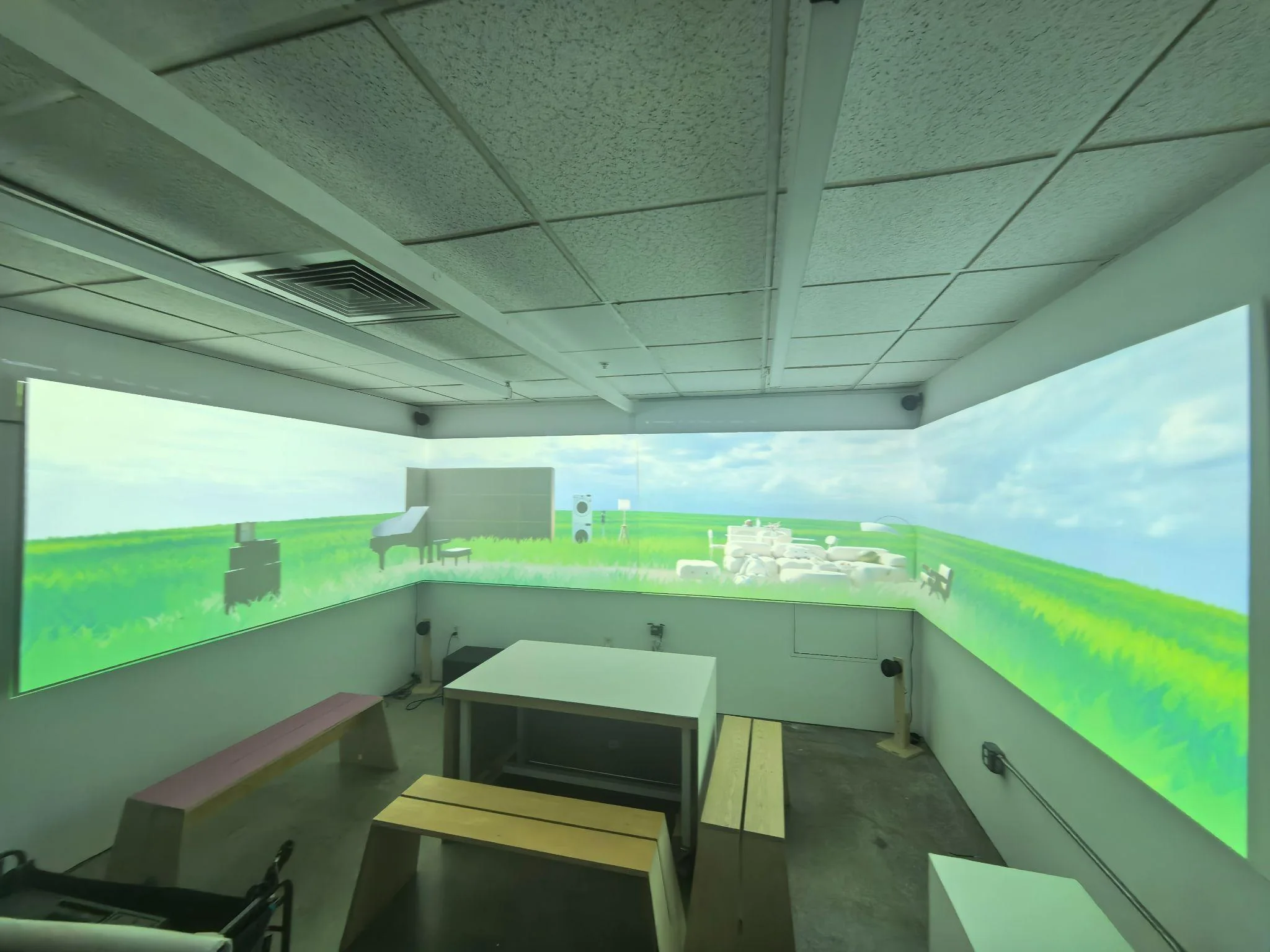 The full-scale Ava prototype projecting a grassy environment across three walls