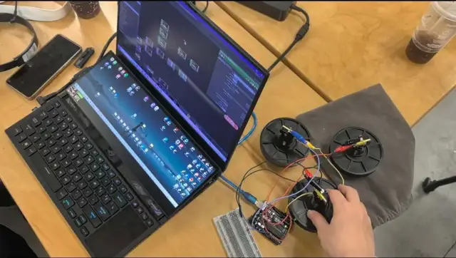 Laptop, microcontroller, and physical rotary controls used during prototyping